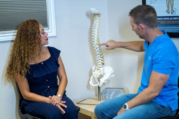 Dr. Dan Foss consulting with patient at Pura Vida Chiropractic San Antonio